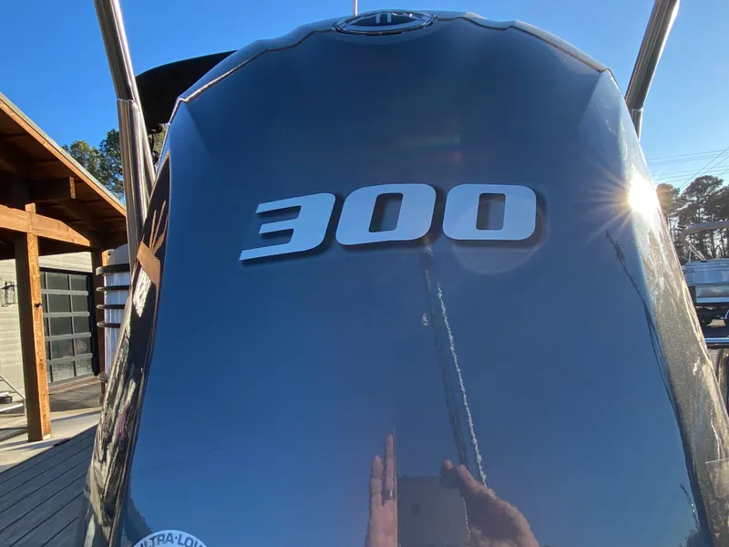 Slide: The Image of 2025 SunCatcher Elite 324 SS boat with "300" engine detail in sunlight. - 5