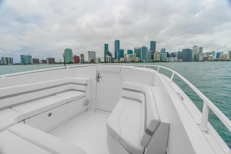 Slide: The Image of 2014 Intrepid 327 Cuddy boat with city skyline in the background. - 15