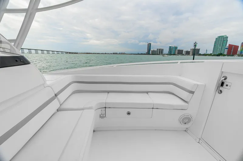 Slide: The Image of 2014 Intrepid 327 Cuddy boat interior with waterfront cityscape view. - 18