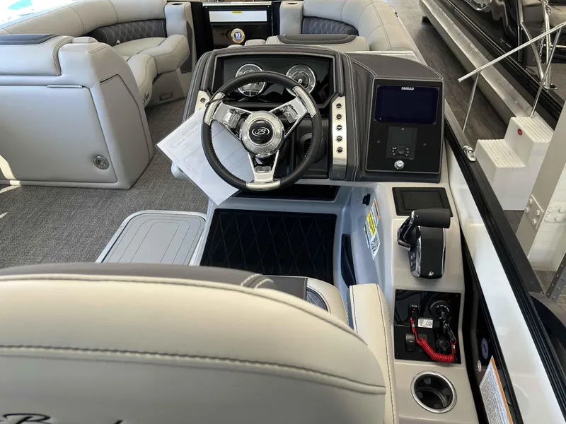 Slide: The Image of 2025 Barletta Lusso 23UC boat interior with modern steering and control panel. - 7