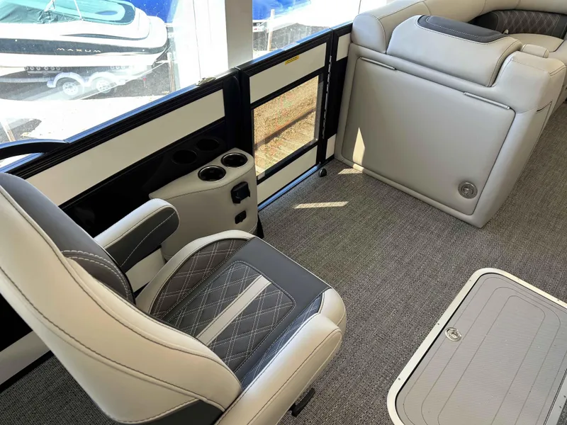 Slide: The Image of 2025 Barletta Lusso 23UC interior with luxurious seating and cup holders. - 8