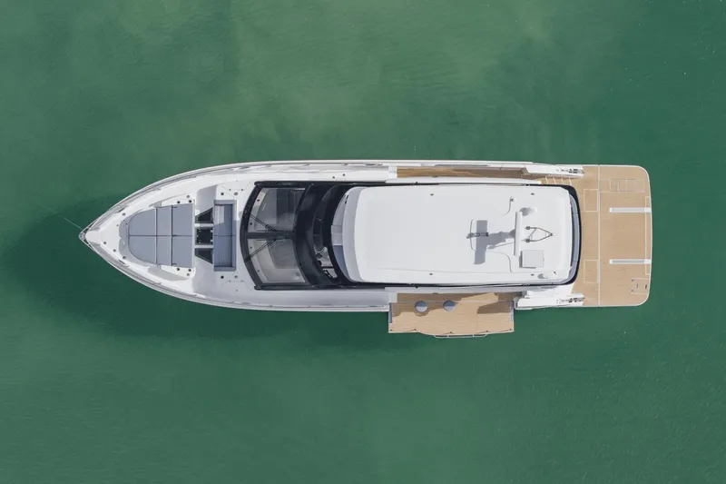 Slide: The Image of Aerial view of 2026 Cruisers Yachts 57 Fly on calm water. - 12