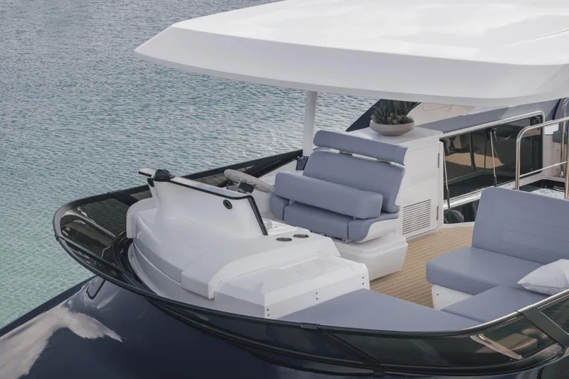 Slide: The Image of 2025 Cruisers Yachts 57 Fly, luxury flybridge with sleek design on calm water. - 16
