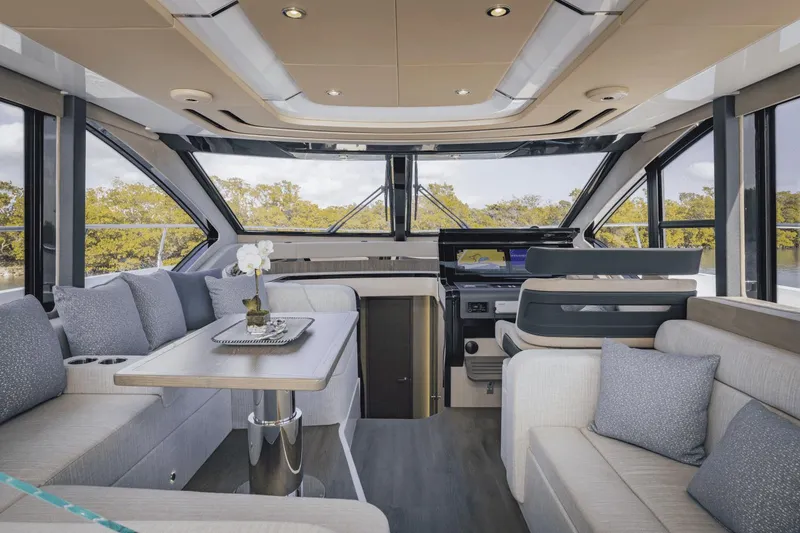 Slide: The Image of Luxurious interior of 2025 Cruisers Yachts 57 Fly with modern seating and panoramic windows. - 36
