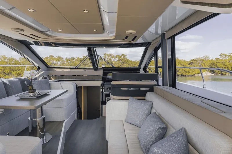 Slide: The Image of Luxurious interior of 2025 Cruisers Yachts 57 Fly with modern seating and panoramic windows. - 38