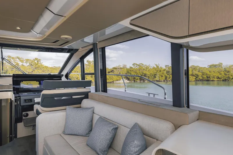 Slide: The Image of Luxurious interior of 2025 Cruisers Yachts 57 Fly, featuring elegant seating and scenic water views. - 39