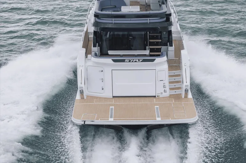 Slide: The Image of 2025 Cruisers Yachts 57 Fly navigating through water, rear view. - 5