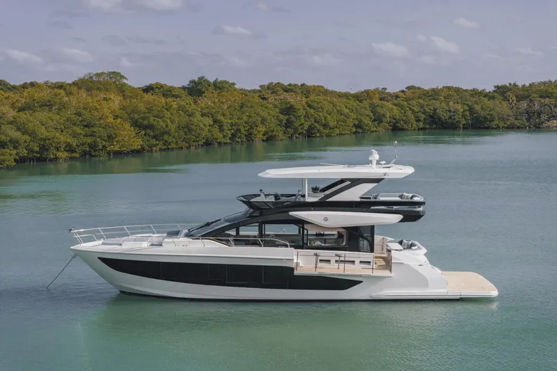 Slide: The Image of Luxury yacht Cruisers Yachts 57 Fly 2026 on calm waters. - 7