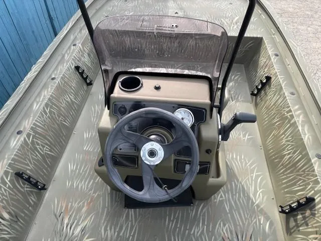Slide: The Image of 2024 Tracker Grizzly 1860 CC boat console with steering wheel and gauges. - 14