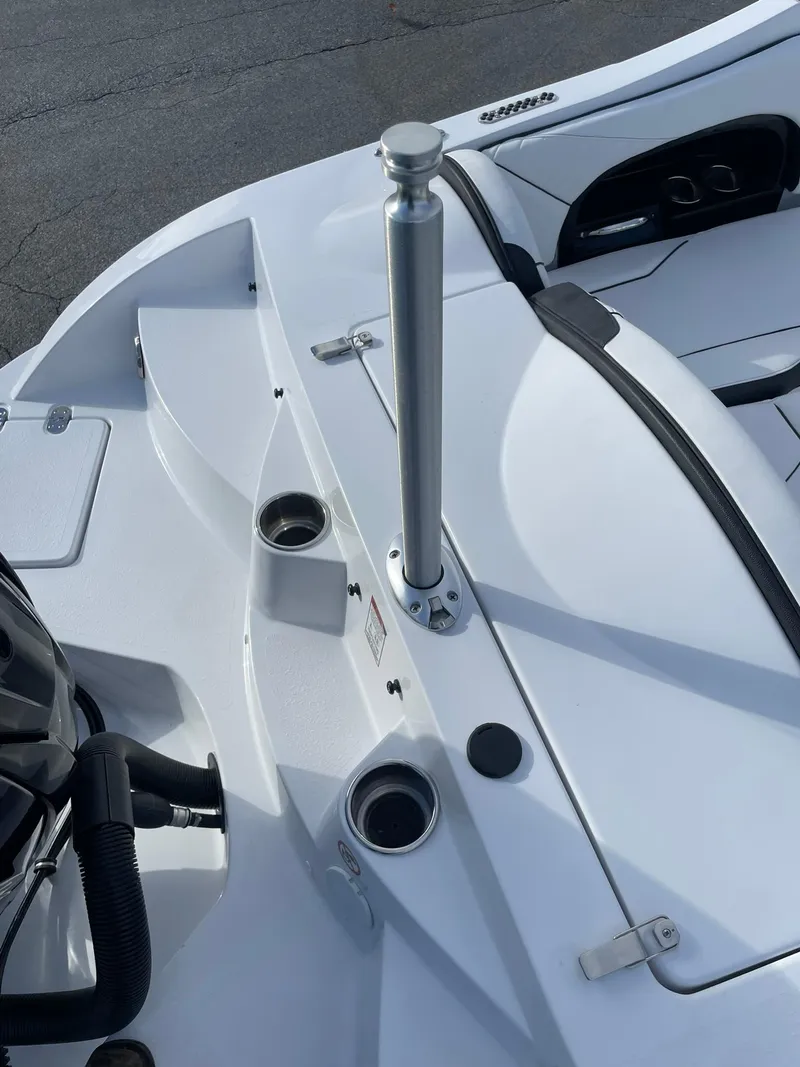 Slide: The Image of 2025 Stingray 23 OSX boat interior with cup holders and seating area. - 10