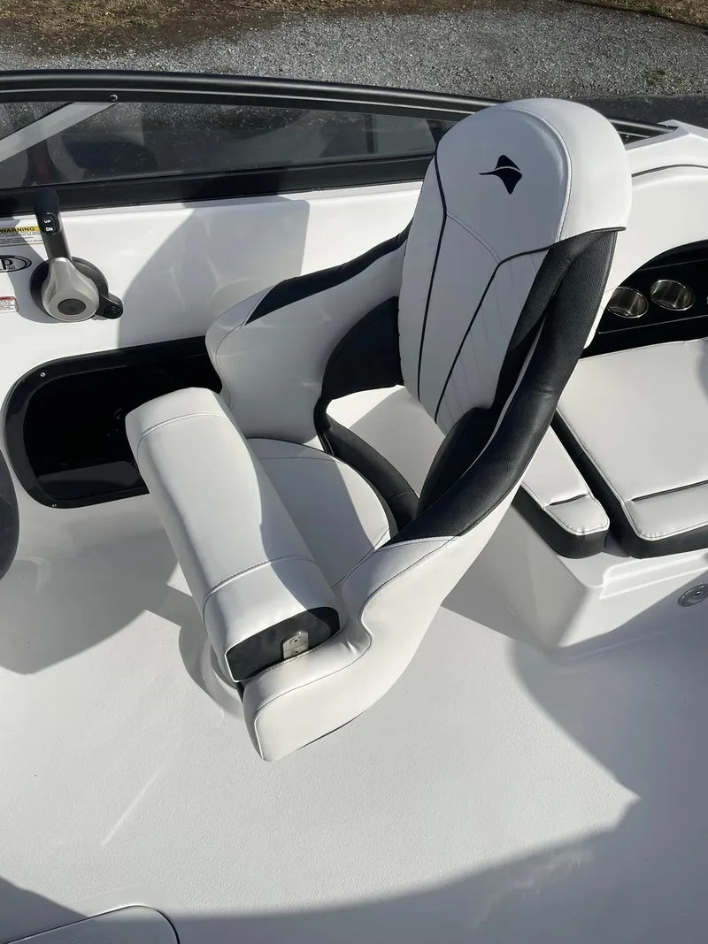 Slide: The Image of 2025 Stingray 23 OSX boat seat, white and black design, modern and sleek interior. - 17