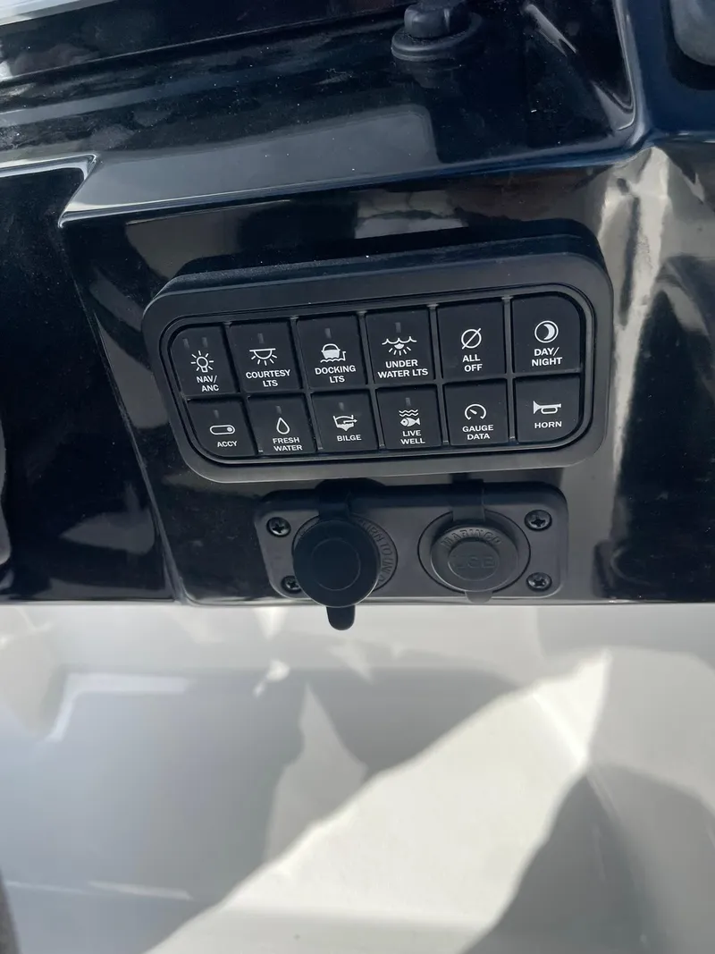 Slide: The Image of Control panel of 2025 Stingray 23 OSX boat with various function buttons. - 22