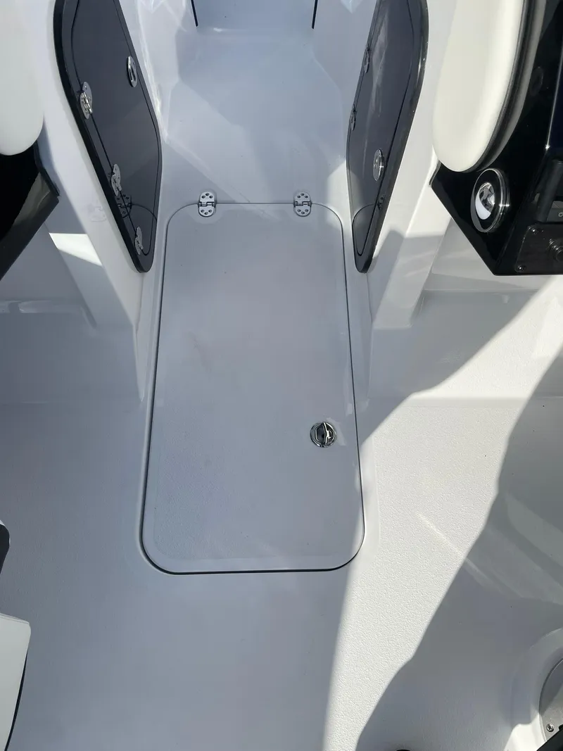 Slide: The Image of 2025 Stingray 23 OSX boat interior, featuring sleek storage compartment and modern design elements. - 26