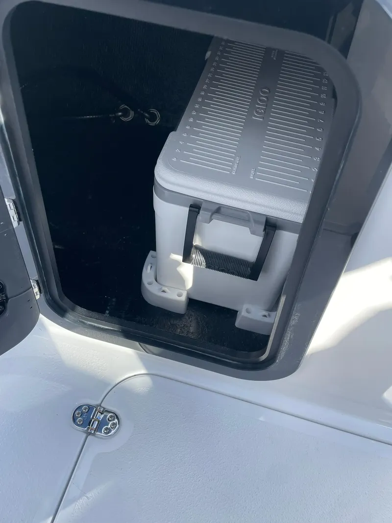 Slide: The Image of Storage compartment with cooler in 2025 Stingray 23 OSX boat. - 27