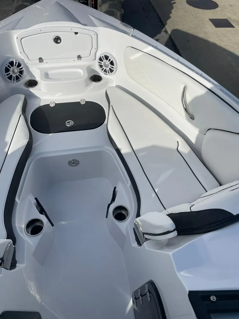Slide: The Image of 2025 Stingray 23 OSX boat interior, featuring sleek white seating and modern design elements. - 30