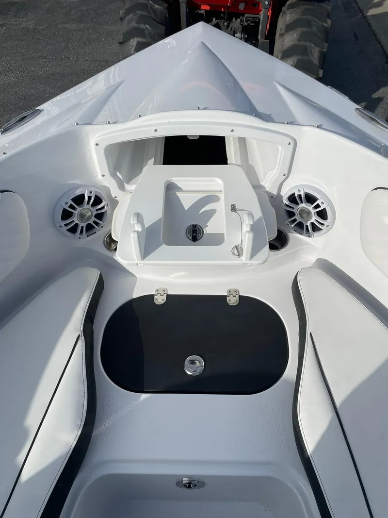Slide: The Image of 2025 Stingray 23 OSX boat interior with speakers and storage compartments. - 32