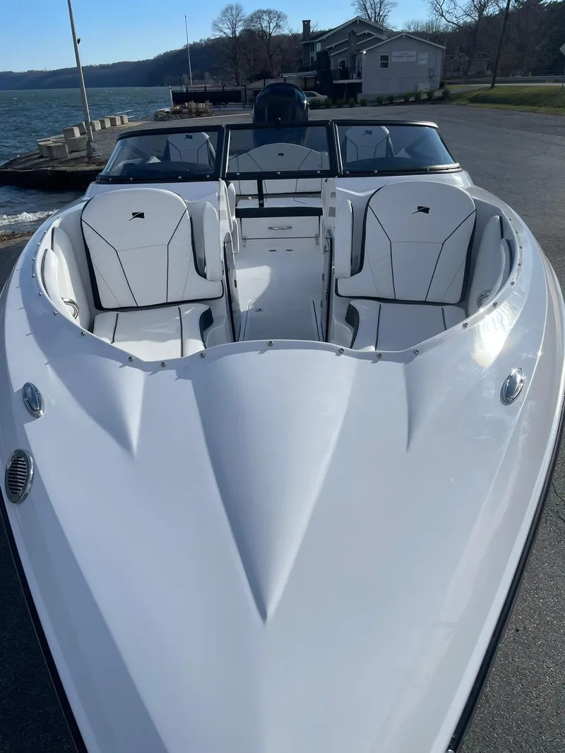 Slide: The Image of 2025 Stingray 23 OSX boat with sleek white design and spacious seating. - 7