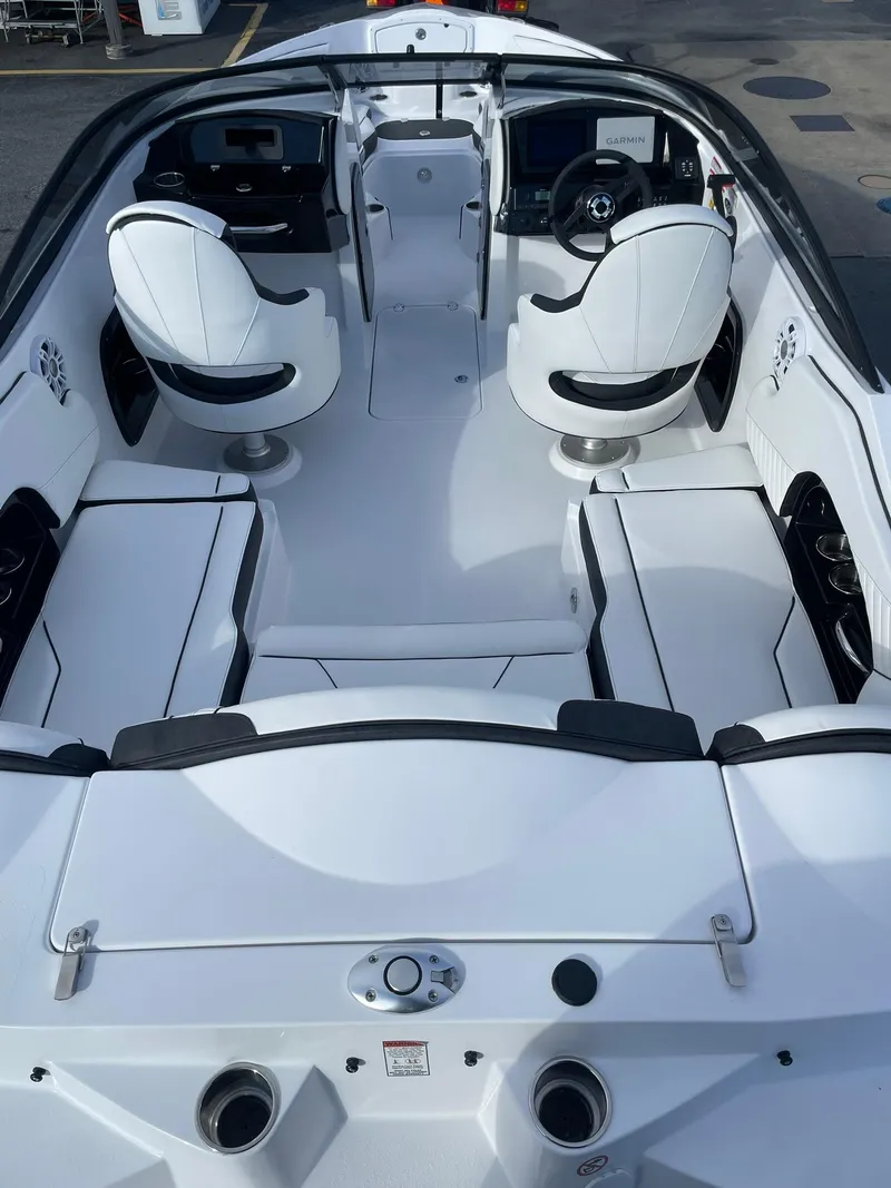 Slide: The Image of 2025 Stingray 23 OSX boat interior with sleek white seating and modern dashboard design. - 8