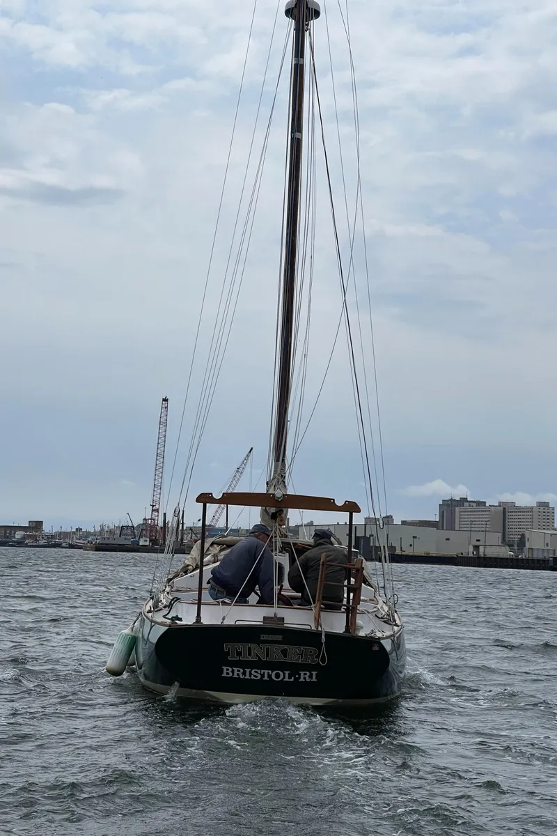 Slide: The Image of Sailboat "Legnos Mystic 30" from 1978 on water near industrial port. - 10