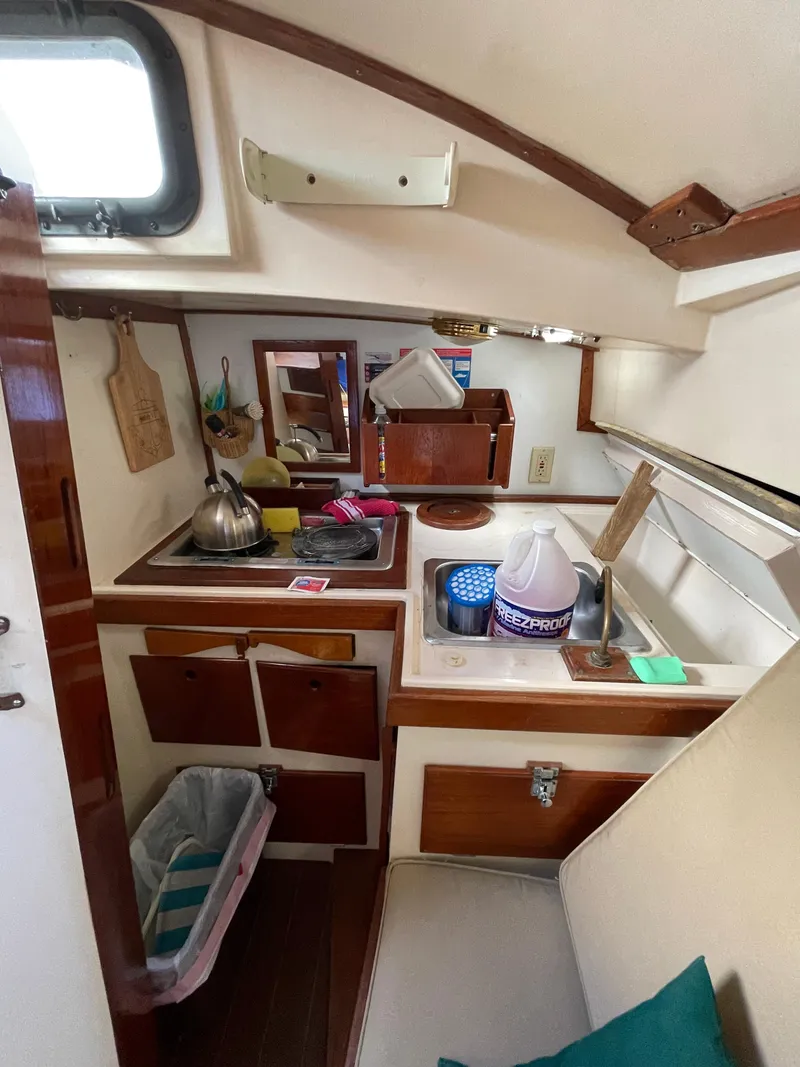 Slide: The Image of Cozy 1978 Legnos Mystic 30 boat kitchen with sink, stove, and storage. - 5