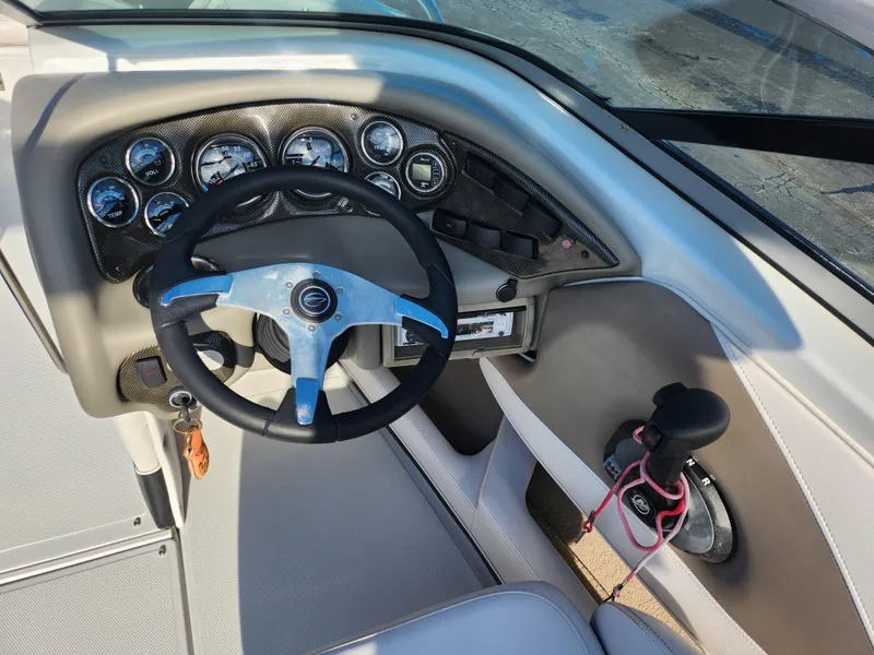Slide: The Image of Steering console of a 2012 Crownline 21 SS boat with gauges and controls. - 12