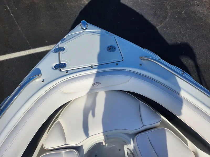 Slide: The Image of Bow seating area of 2012 Crownline 21 SS boat with white upholstery. - 16