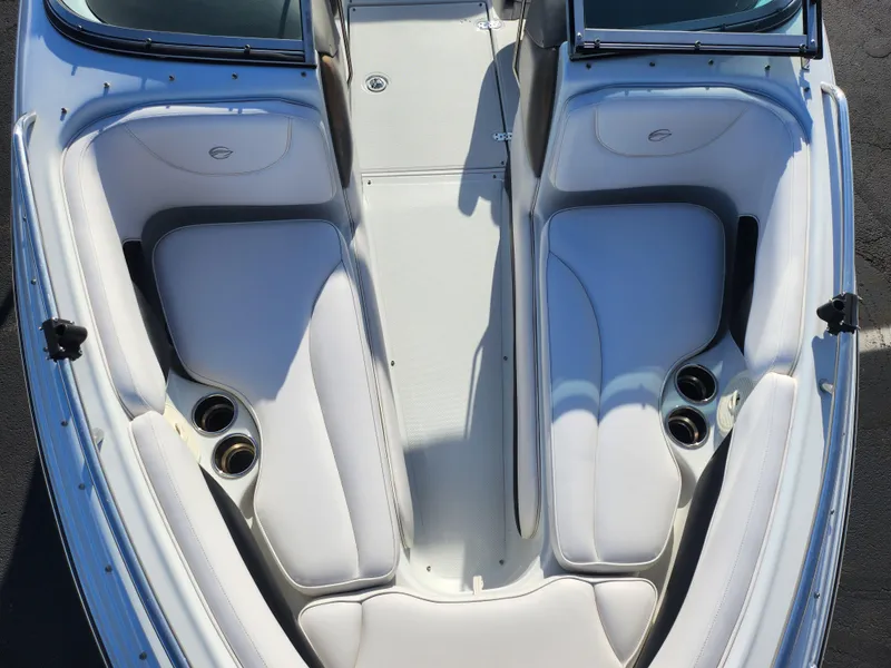 Slide: The Image of 2012 Crownline 21 SS boat interior with white seating and cup holders. - 17