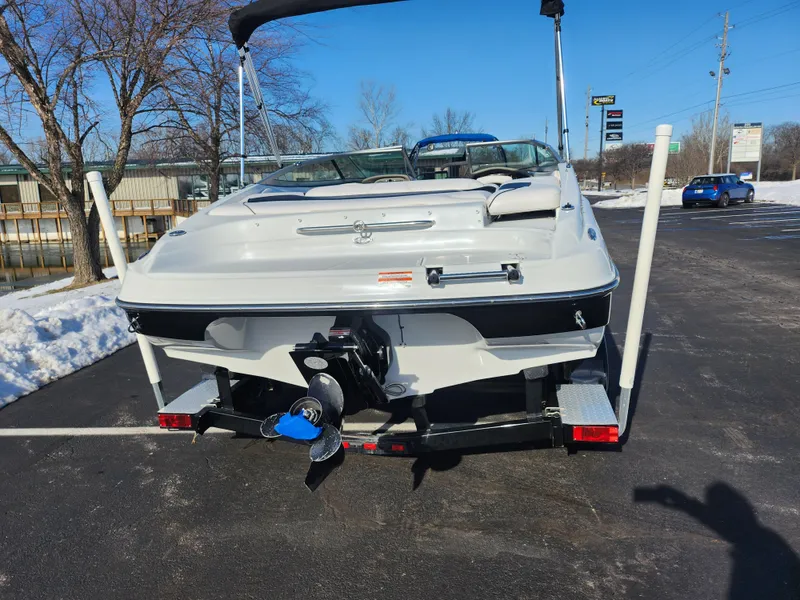 Slide: The Image of 2012 Crownline 21 SS boat on trailer, parked on snowy pavement. - 2