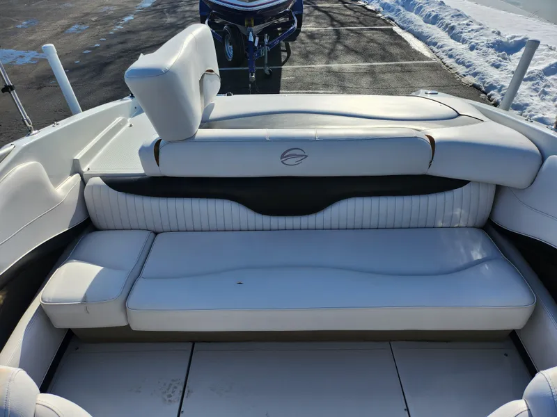 Slide: The Image of 2012 Crownline 21 SS boat interior with white seating and snowy background. - 20