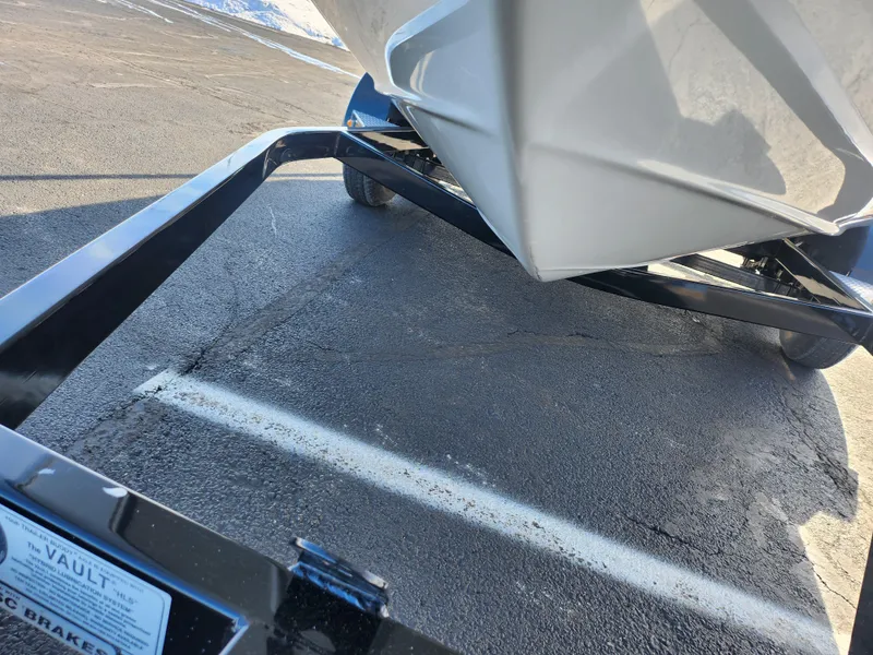 Slide: The Image of 2012 Crownline 21 SS boat on a trailer, parked on asphalt. - 7