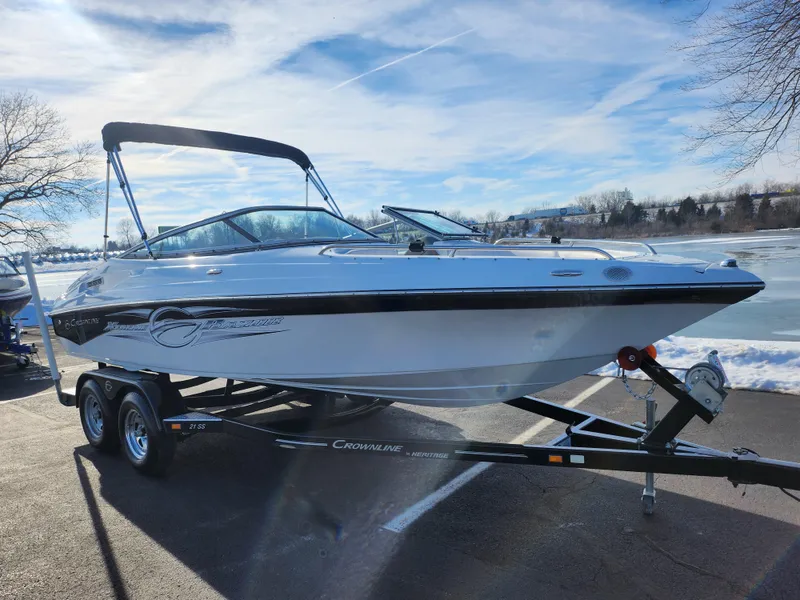 Slide: The Image of 2012 Crownline 21 SS boat on trailer by a lake under a clear sky. - 8
