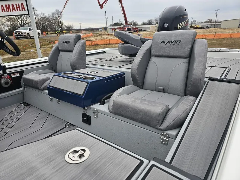 Slide: The Image of 2025 Avid 18 Vertex Crappie boat interior with gray seating and Yamaha engine. - 4