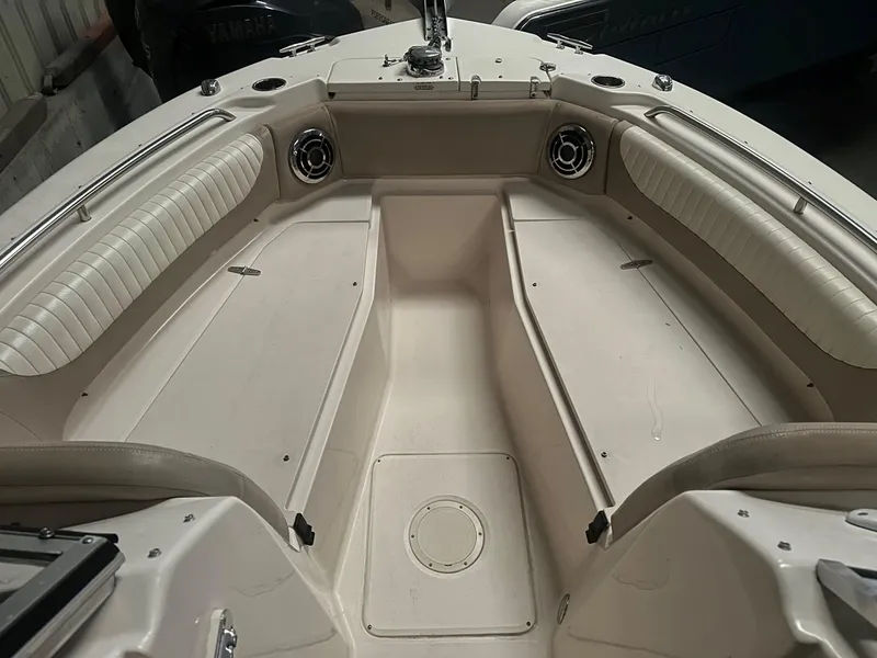 Slide: The Image of 2014 Grady-White Freedom 255 boat interior with cushioned seating and speakers. - 2