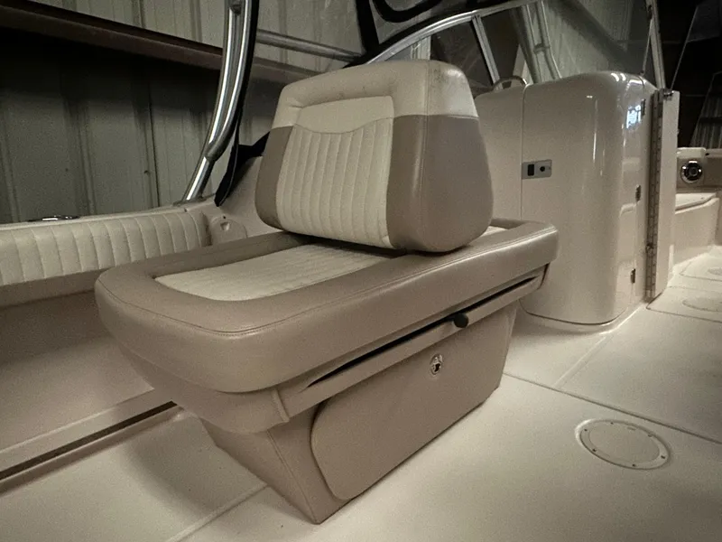 Slide: The Image of 2014 Grady-White Freedom 255 boat interior with beige seating and storage compartment. - 4
