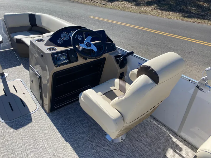 Slide: The Image of Interior of 2025 SunCatcher Select 322RC boat with beige seating and modern dashboard. - 11