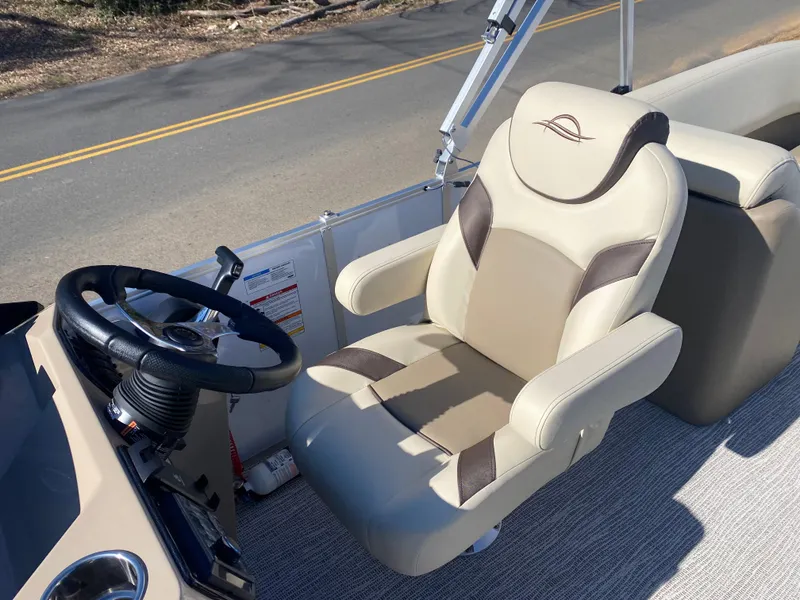Slide: The Image of Captain's chair and steering wheel of 2025 SunCatcher Select 322RC boat. - 14
