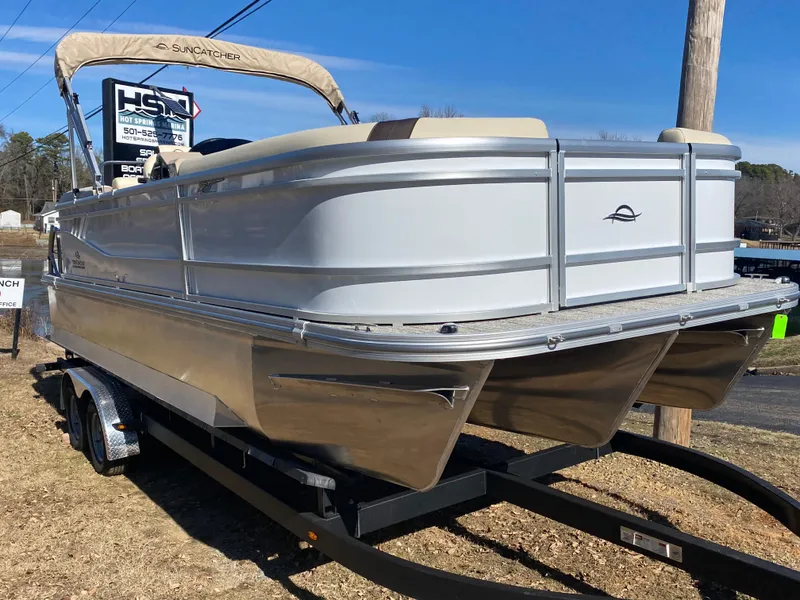Slide: The Image of 2025 SunCatcher Select 322RC pontoon boat on trailer, silver exterior, parked outdoors. - 2