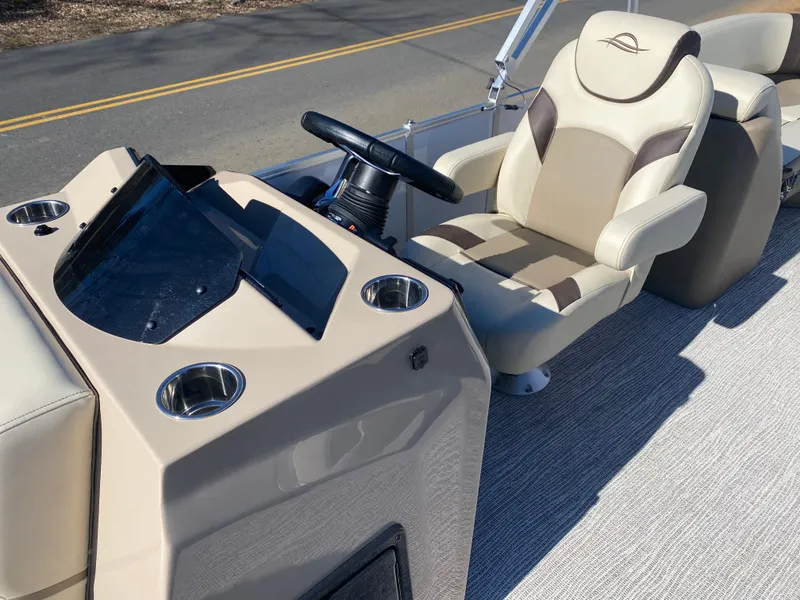 Slide: The Image of 2025 SunCatcher Select 322RC boat interior with steering console and comfortable seating. - 24