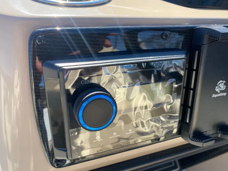 Slide: The Image of Close-up of a 2025 SunCatcher Select 322RC audio system with blue-lit control knob. - 27