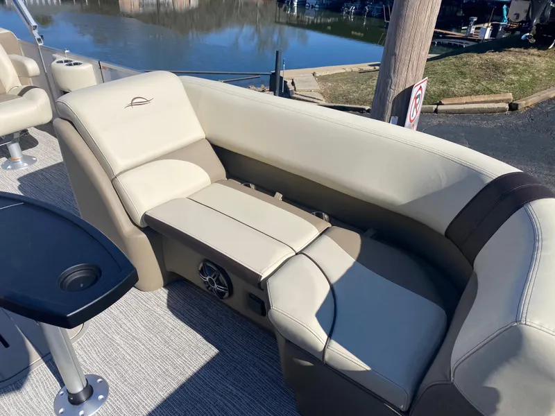 Slide: The Image of Luxurious seating on 2025 SunCatcher Select 322RC pontoon boat, featuring beige upholstery and cup holders. - 28