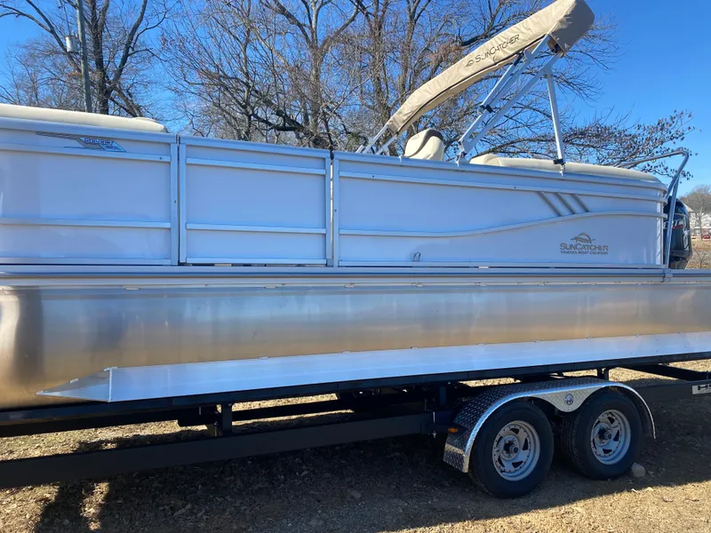 Slide: The Image of 2025 SunCatcher Select 322RC pontoon boat on trailer, side view, outdoors. - 3