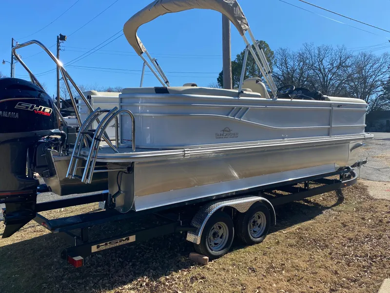 Slide: The Image of 2025 SunCatcher Select 322RC pontoon boat on trailer, featuring Yamaha outboard motor. - 6