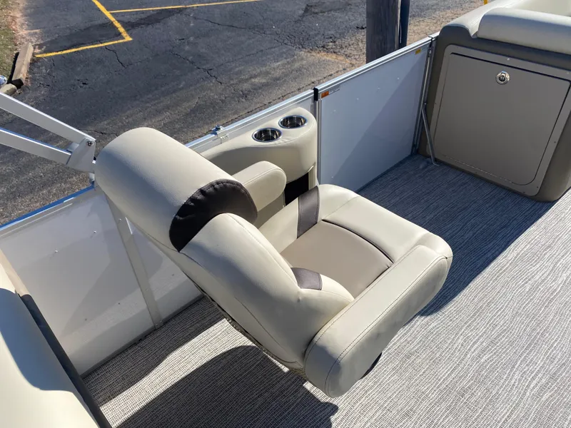Slide: The Image of 2025 SunCatcher Select 322RC boat seat with cup holders, featuring beige upholstery and modern design. - 9