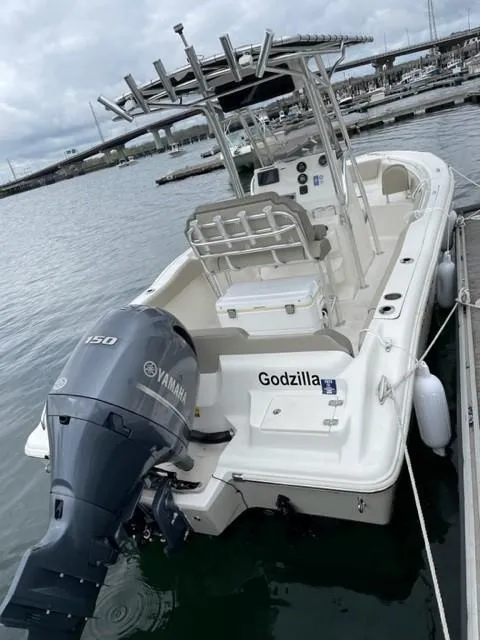 Slide: The Image of 2022 Key West 219 FS boat docked, featuring a Yamaha 150 engine. - 3