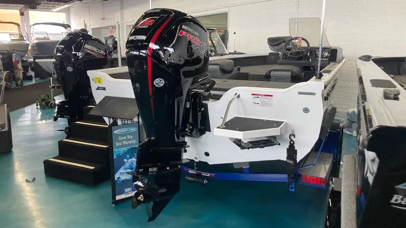 Slide: The Image of 2025 Crestliner 1750 Fish Hawk boat with dual outboard motors in showroom. - 1