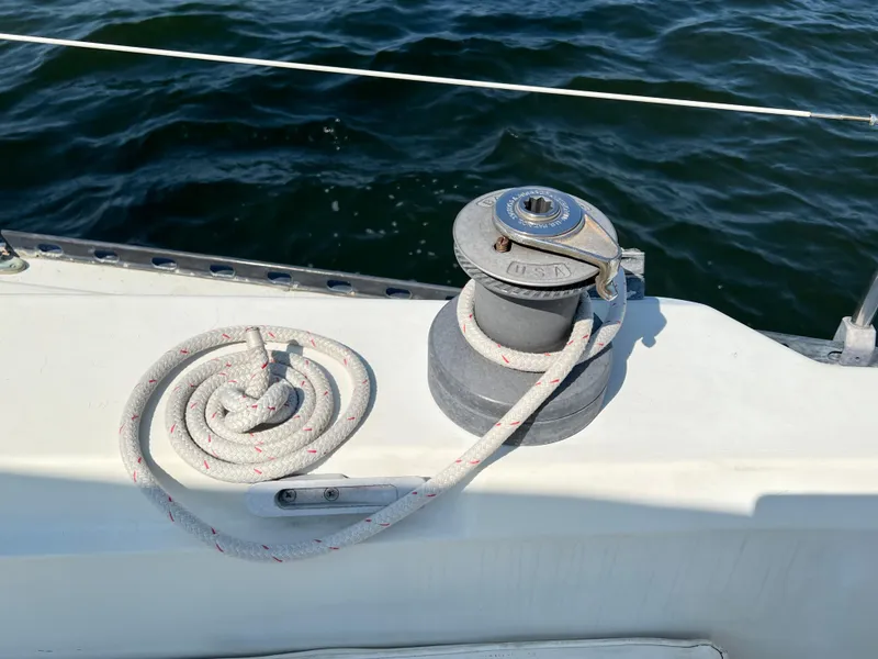 Slide: The Image of Winch and rope on 1983 C&C 35 MKIII sailboat deck, with ocean background. - 12