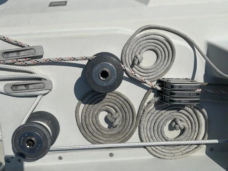 Slide: The Image of Sailing equipment on 1983 C&C 35 MKIII yacht, featuring coiled ropes and pulleys. - 19