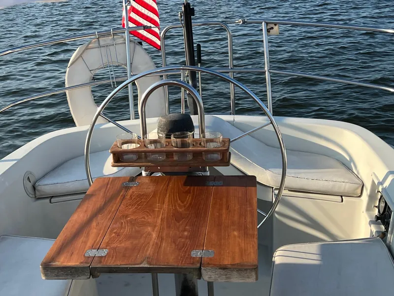 Slide: The Image of Cockpit of 1983 C&C 35 MKIII sailboat with wooden table and American flag. - 21