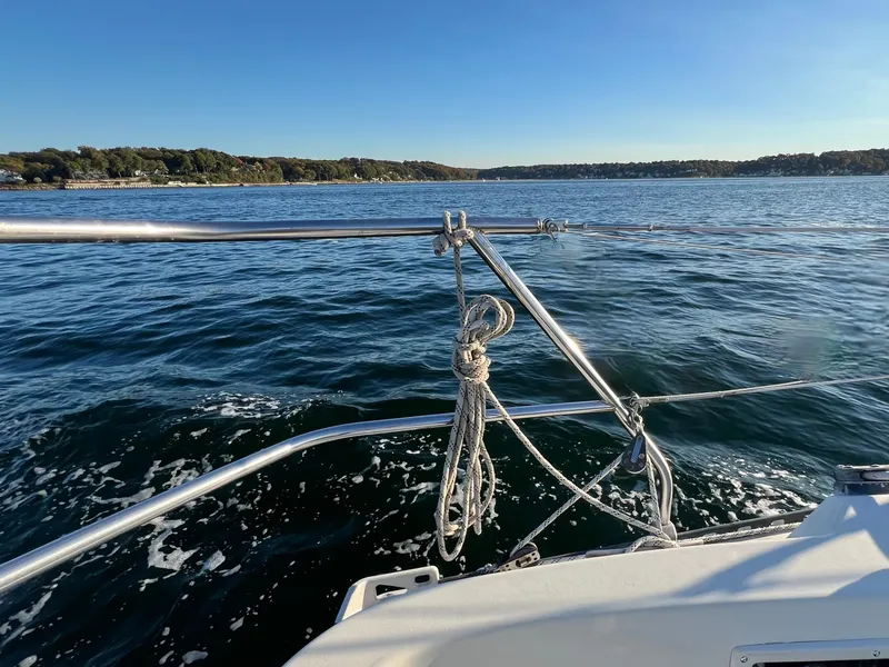 Slide: The Image of Sailing on a 1983 C&C 35 MKIII yacht, serene waters, clear blue sky. - 25
