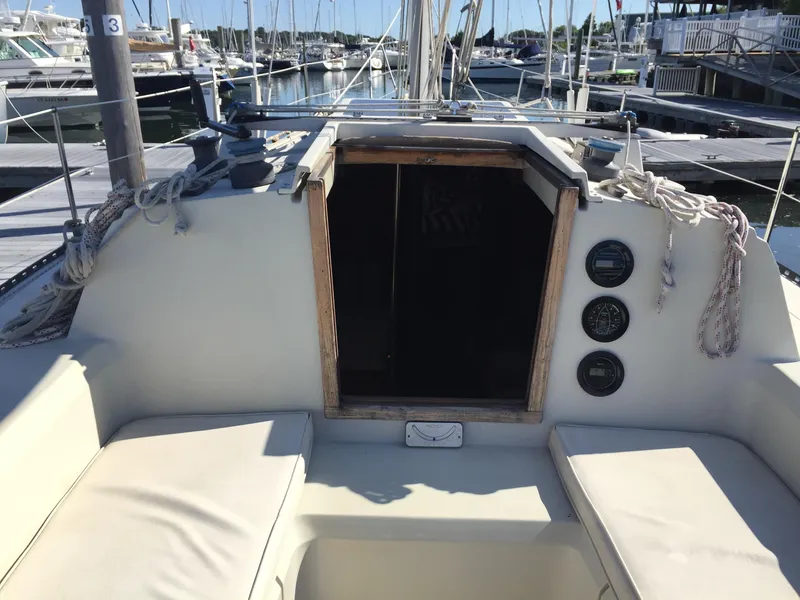 Slide: The Image of Cockpit of 1983 C&C 35 MKIII sailboat, docked at marina with visible seating and instruments. - 27